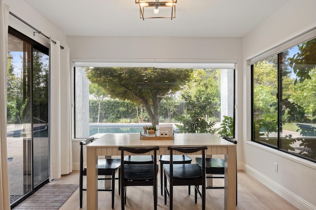 2734 W Bluff Ave, Fresno, CA 93711 - dining area featuring plenty of natural light, a chandelier, and light wood finished floors