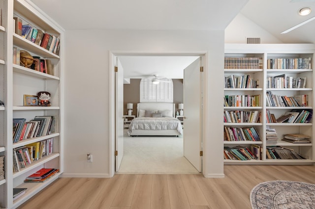2734 W Bluff Ave, Fresno, CA 93711 - sitting room featuring wood finished floors, wall of books, and lofted ceiling