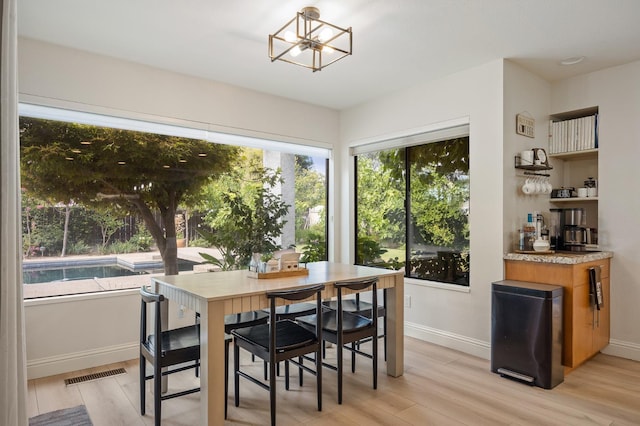 2734 W Bluff Ave, Fresno, CA 93711 - dining room featuring a chandelier and light wood-type flooring