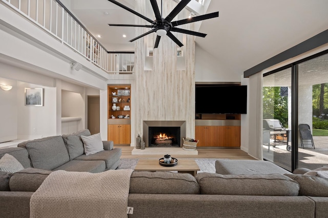 2734 W Bluff Ave, Fresno, CA 93711 - living area featuring a high ceiling, a fireplace, a ceiling fan, and wood finished floors