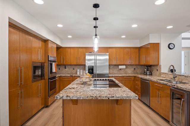 2734 W Bluff Ave, Fresno, CA 93711 - kitchen featuring stainless steel appliances, wine cooler, brown cabinets, light wood-type flooring, and recessed lighting