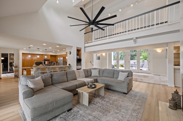 2734 W Bluff Ave, Fresno, CA 93711 - living room featuring a high ceiling, light wood-type flooring, ceiling fan, french doors, and track lighting