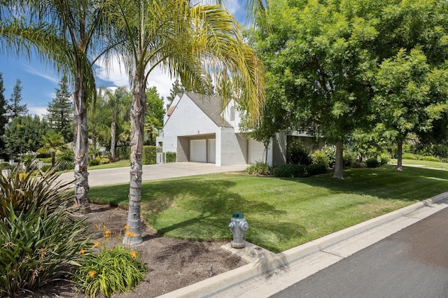 2734 W Bluff Ave, Fresno, CA 93711 - view of front facade with a garage, driveway, stucco siding, and a front yard