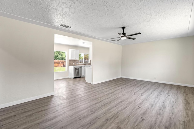 4729 E Cornell Ave, Fresno, CA 93703 - unfurnished living room with wood finished floors, a ceiling fan, and a textured ceiling