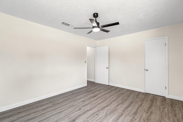 4729 E Cornell Ave, Fresno, CA 93703 - unfurnished bedroom featuring wood finished floors, a textured ceiling, and ceiling fan