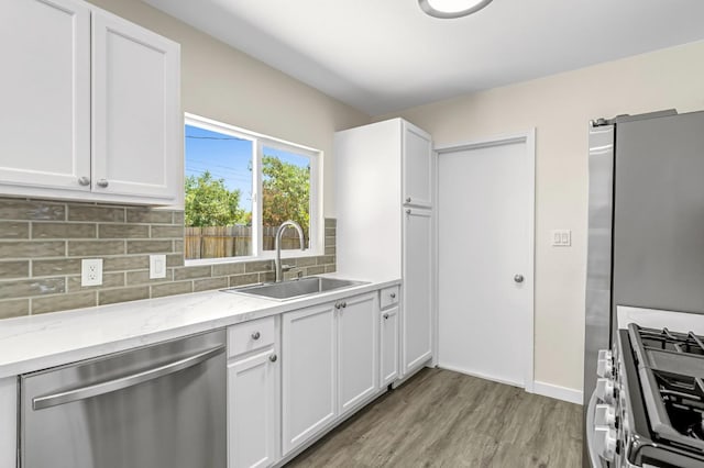4729 E Cornell Ave, Fresno, CA 93703 - kitchen featuring stainless steel appliances, light wood-style flooring, white cabinets, light stone countertops, and decorative backsplash