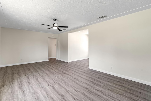 4729 E Cornell Ave, Fresno, CA 93703 - empty room with ceiling fan, a textured ceiling, and wood finished floors