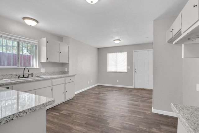 3137 E Townsend Ave, Fresno, CA 93702 - kitchen with light countertops, dark wood-style flooring, and white cabinets
