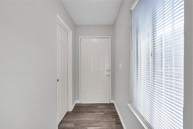 3137 E Townsend Ave, Fresno, CA 93702 - hall with dark wood-style flooring and a textured ceiling