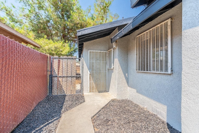 3137 E Townsend Ave, Fresno, CA 93702 - doorway to property featuring stucco siding and a gate