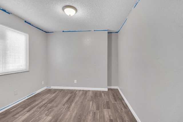 3137 E Townsend Ave, Fresno, CA 93702 - spare room with a textured ceiling and wood finished floors