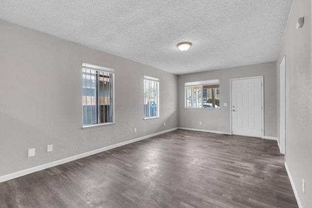 3137 E Townsend Ave, Fresno, CA 93702 - unfurnished room with healthy amount of natural light, a textured ceiling, and dark wood-style flooring