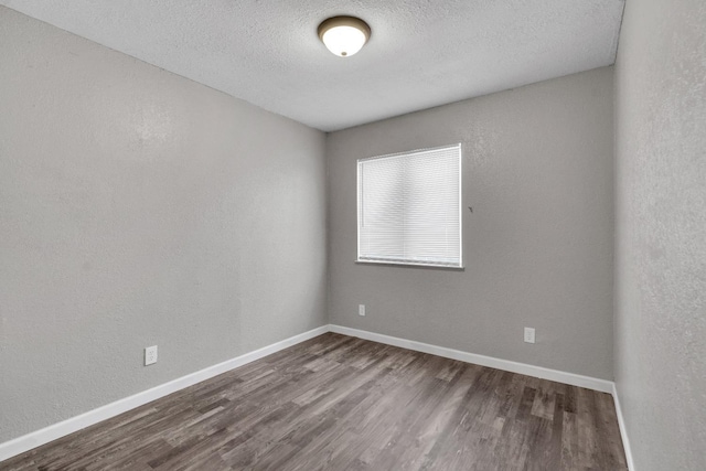 3137 E Townsend Ave, Fresno, CA 93702 - unfurnished room featuring dark wood finished floors and a textured ceiling