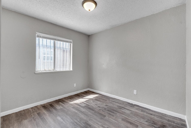 3137 E Townsend Ave, Fresno, CA 93702 - unfurnished room with wood finished floors and a textured ceiling