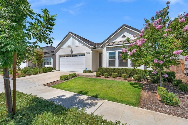 2062 N Osmun Ave, Clovis, CA 93619 - view of front of home featuring a garage, driveway, a front yard, and stucco siding