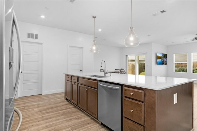 2062 N Osmun Ave, Clovis, CA 93619 - kitchen featuring appliances with stainless steel finishes, light wood finished floors, light countertops, ceiling fan, and recessed lighting