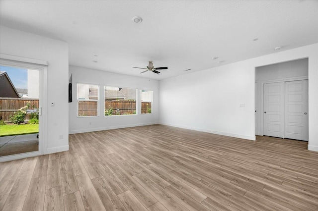 2062 N Osmun Ave, Clovis, CA 93619 - unfurnished living room with light wood-style floors and ceiling fan