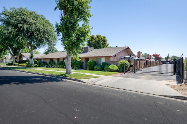 5090 N College Ave Unit 103, Fresno, CA 93704 - ranch-style home featuring a gate, a shingled roof, and a residential view