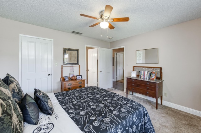 5090 N College Ave Unit 103, Fresno, CA 93704 - bedroom featuring light colored carpet, a textured ceiling, and a ceiling fan