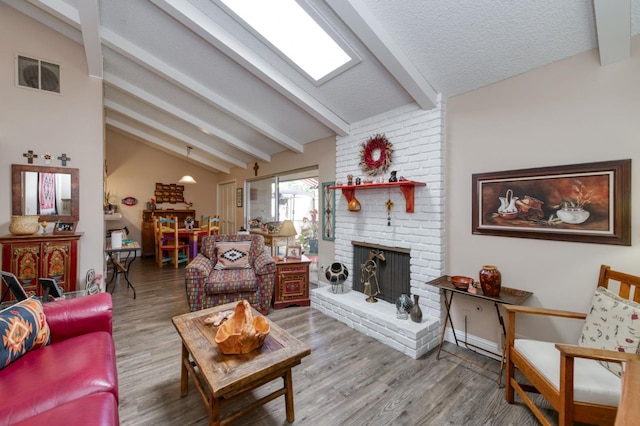 5090 N College Ave Unit 103, Fresno, CA 93704 - living area with a brick fireplace and wood finished floors