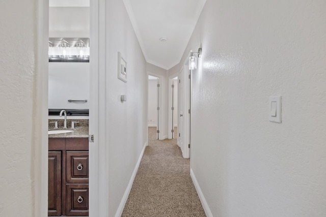 3012 W Santa Ana Ave, Fresno, CA 93722 - hallway with a sink and light carpet