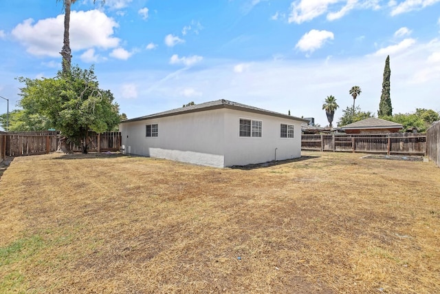 3012 W Santa Ana Ave, Fresno, CA 93722 - back of property featuring a fenced backyard and stucco siding