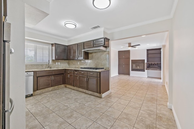3012 W Santa Ana Ave, Fresno, CA 93722 - kitchen featuring a ceiling fan, white dishwasher, under cabinet range hood, light tile patterned flooring, and crown molding