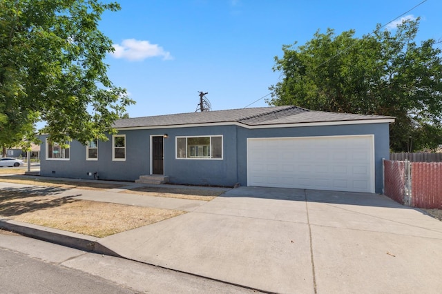 4545 E Grant Ave, Fresno, CA 93702 - single story home with driveway, a garage, and stucco siding
