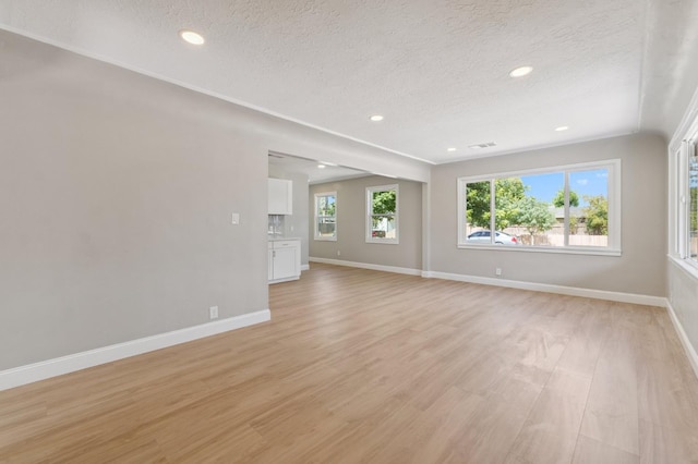 4545 E Grant Ave, Fresno, CA 93702 - spare room featuring light wood finished floors, a textured ceiling, and recessed lighting