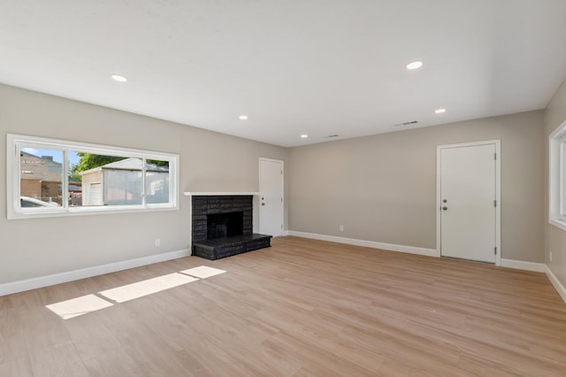 4545 E Grant Ave, Fresno, CA 93702 - unfurnished living room featuring light wood-style flooring, a fireplace, and recessed lighting