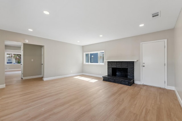 4545 E Grant Ave, Fresno, CA 93702 - unfurnished living room featuring healthy amount of natural light, a fireplace, light wood finished floors, and recessed lighting