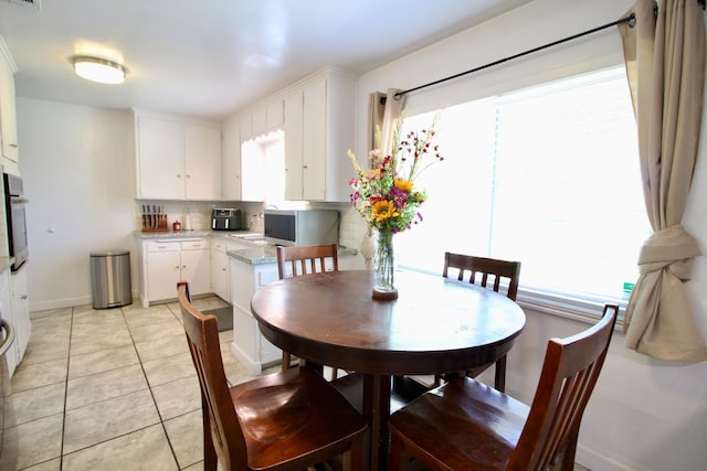 3377 E Richert Ave, Fresno, CA 93726 - dining space featuring light tile patterned floors and baseboards