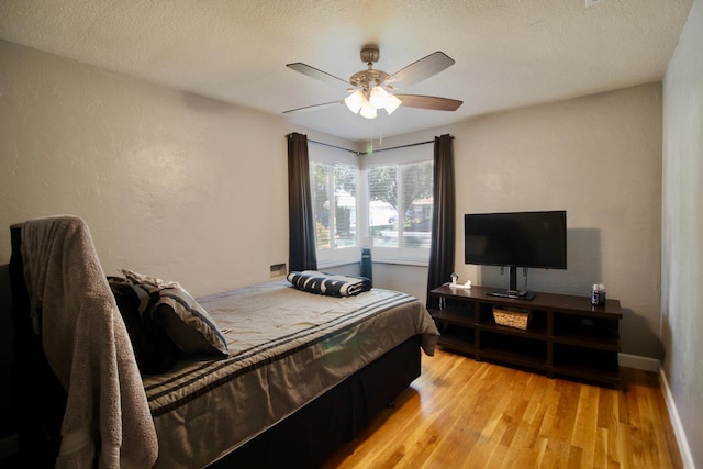 3377 E Richert Ave, Fresno, CA 93726 - bedroom with light wood-type flooring, ceiling fan, a textured ceiling, and a textured wall