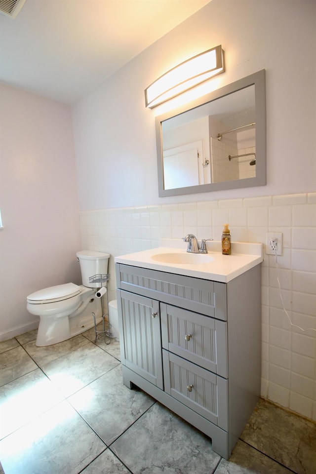 3377 E Richert Ave, Fresno, CA 93726 - full bath with tile walls, vanity, tile patterned flooring, a shower, and a wainscoted wall