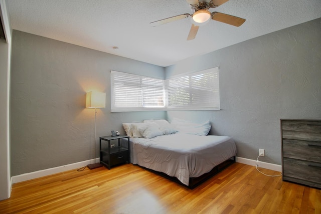 3377 E Richert Ave, Fresno, CA 93726 - bedroom featuring light wood-style flooring, a textured wall, and ceiling fan
