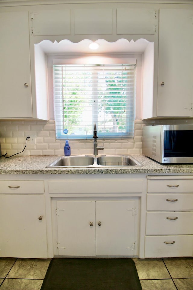 3377 E Richert Ave, Fresno, CA 93726 - kitchen featuring stainless steel microwave, white cabinets, backsplash, and light countertops