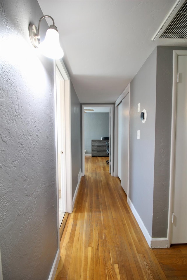 3377 E Richert Ave, Fresno, CA 93726 - hallway featuring hardwood / wood-style floors and a textured wall
