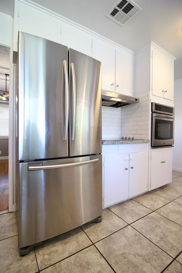 3377 E Richert Ave, Fresno, CA 93726 - kitchen featuring stainless steel appliances, under cabinet range hood, tasteful backsplash, light countertops, and white cabinets