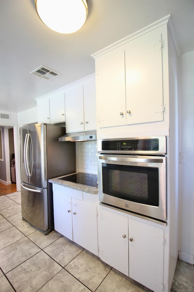 3377 E Richert Ave, Fresno, CA 93726 - kitchen featuring stainless steel appliances, under cabinet range hood, decorative backsplash, white cabinetry, and light countertops