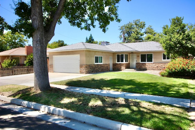 3377 E Richert Ave, Fresno, CA 93726 - ranch-style house featuring stucco siding, stone siding, an attached garage, and driveway