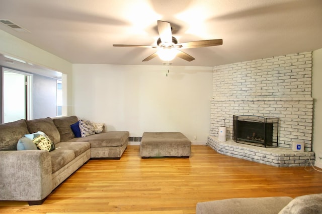 3377 E Richert Ave, Fresno, CA 93726 - living area with ceiling fan, light wood-style floors, and a fireplace