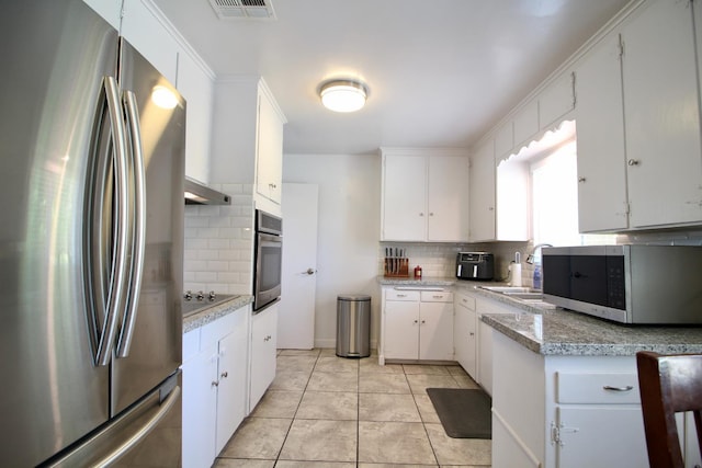 3377 E Richert Ave, Fresno, CA 93726 - kitchen featuring appliances with stainless steel finishes, decorative backsplash, light countertops, and white cabinets