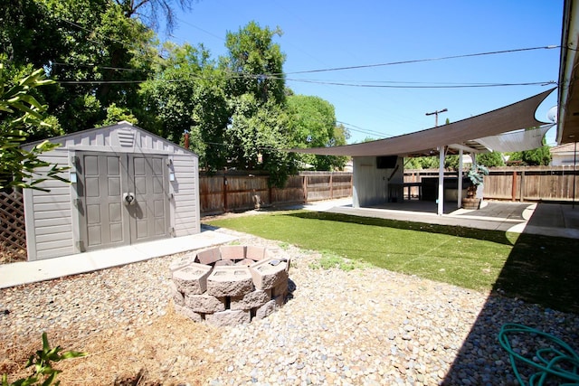 3377 E Richert Ave, Fresno, CA 93726 - fenced backyard with a storage shed, a fire pit, and a patio area
