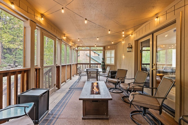 40416 Wild Rose Ln, Shaver Lake, CA 93664 - sunroom featuring a fire pit, french doors, carpet, and outdoor dining space