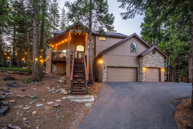40416 Wild Rose Ln, Shaver Lake, CA 93664 - view of front of home featuring stone siding, driveway, an attached garage, and stairs