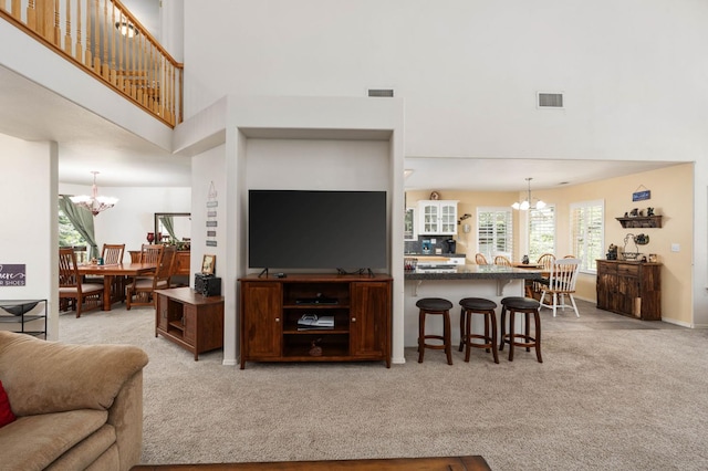 40416 Wild Rose Ln, Shaver Lake, CA 93664 - living room featuring a chandelier, a high ceiling, and light colored carpet