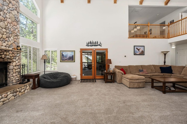 40416 Wild Rose Ln, Shaver Lake, CA 93664 - carpeted living area with a towering ceiling, a stone fireplace, french doors, and beam ceiling