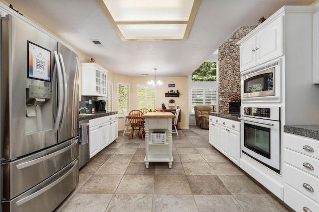 40416 Wild Rose Ln, Shaver Lake, CA 93664 - kitchen with appliances with stainless steel finishes, a chandelier, dark countertops, and white cabinetry