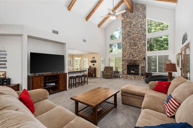 40416 Wild Rose Ln, Shaver Lake, CA 93664 - carpeted living room featuring high vaulted ceiling, beamed ceiling, ceiling fan, and a fireplace