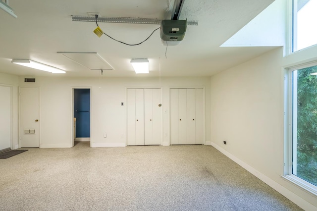 2805 W Spruce Ave, Fresno, CA 93711 - unfurnished bedroom featuring multiple closets, multiple windows, a garage, and carpet floors
